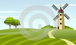 Rural landscape with windmill and meadow or paddy field.