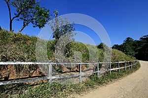 Wooden fence bordering dirt road photo