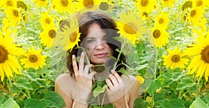 Rural landscape with young beautiful sexy brunette woman, in a field of yellow sunflowers