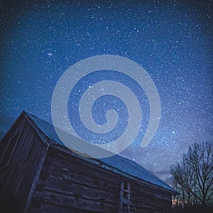 Rural Log Cabin barn at night with stars and milky way