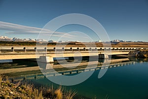 Rural MacKenzie country hydro canal and snow capped mountains photo