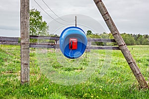 Rural public telephone on a green field