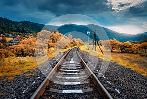 Rural railroad in mountains in overcast day. Old railway