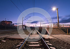 Rural railway station at night with blue sky. Railroad