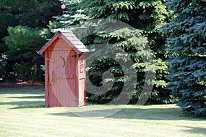 rural red outhouse privy toilet building forest glade photo