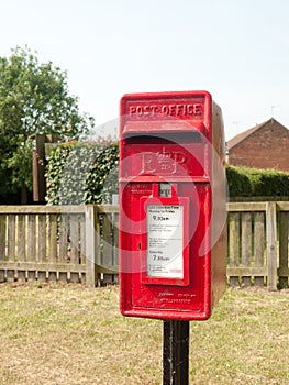 Rural red royal mail box rustic outside street village