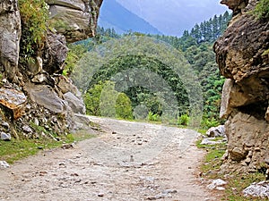 Rural road and green plants in mountains with cloudy sky in Nepal