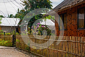 Rural road with houses in the Philippines. Pandan, Panay