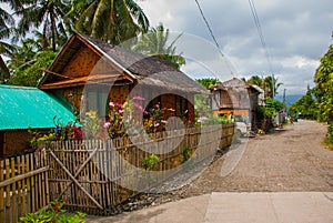 Rural road with houses in the Philippines. Pandan, Panay