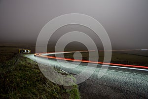 Rural road at night in the fog - cat and fiddle