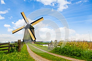 Rural road and windmill in Netherlands