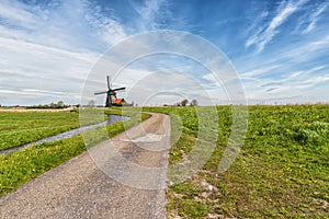 A Rural road and windmill in Netherlands