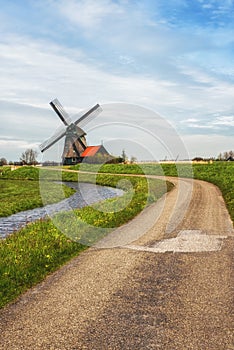 A Rural road and windmill in Netherlands