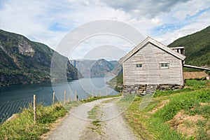 rural road and wooden house at majestic Aurlandsfjord Flam