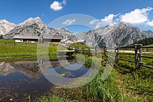 Rural scene in Alps with a lake in the foreground. Austria, Walderalm