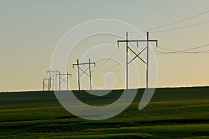 Rural scene with electricity pylons at sunset photo