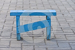 Rural scene, handmade small outdoor bench, wood stool, painted with blue paint