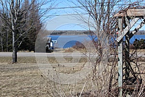 A rural scene in Nova Scotia with a fishing boat and the bay in the background
