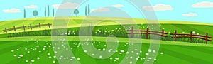 Rural spring landscape countryside with farm field with green grass, flowers, trees. Farmland. Outdoor village scenery