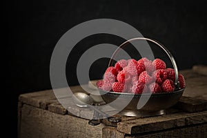 Rural still life with raspberries on rustic table