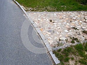 rural stone paving urban square made of quartz cobbles size about 15cm joints filled with gravel brown beige white yellow color