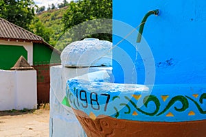 Rural stone washbasin with an inexhaustible spring in 1987. Background with selective focus