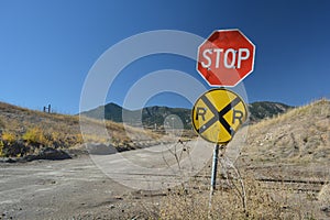 Rural Stop Sign and Dirt Road Railroad Crossing in the Mountains