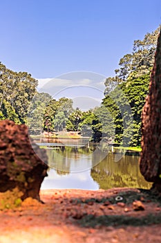 Rural Sunny Water Pond Scene with blue sky - Pond of water with a sunny reflection of trees in a wooded rural area of Siem Reap.