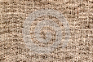 Rural texture of sackcloth. Background of very coarse, rough fabric woven made of flax, jute or hemp. Burlap bag material. Design