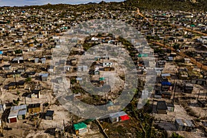 Rural, township and poverty with shacks, houses or informal settlement of land or squatter camps in South Africa. Aerial