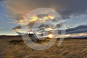 Rural and traditional turfy shelter. Romantic sunset during the winter in Iceland, Europe