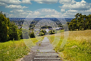 Rural trail on a lush valley with a view of Melbourne, Australia