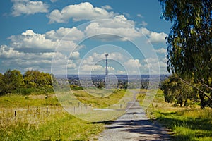 Rural trail on a lush valley with a view of Melbourne, Australia