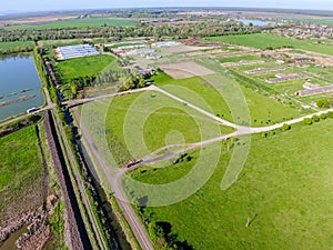 Rural . View from above. On the horizon there is a poultry farm, a field, forest belts and a river