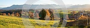 Rural village Aidling in autumn, evening mood with view to mountain range bavarian alps