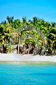 Rural white sand beach with typical native houses of south east Asia