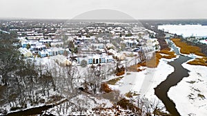 Rural winter aerial view of countryside village at the river