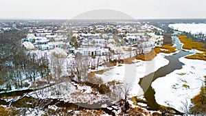 Rural winter aerial view of countryside village at the river