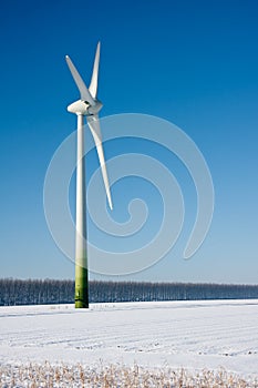 Rural winter landscape with a big windturbine