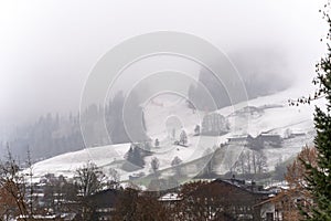 Rural winter landscape on a foggy day in Kitzbuhel, Austria