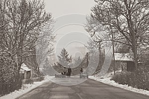 rural winter landscape in the hill area with households and human activities