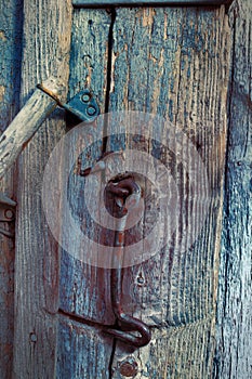 Rural wooden door with a metal hook