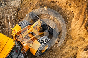 The modern excavator performs excavation work on the construction site