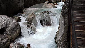 Rushing foaming fast flowing water between the rocks in a narrow gorge