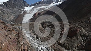 Rushing glacial melt stream from the Palla Bianca glacier in strong retreat