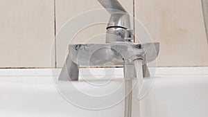 A Rushing Stream of Water Flows into the Sink from an Open Tap. Close up