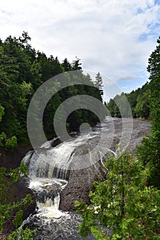 Rushing waterfall in a wilderness area on a hazy summer day