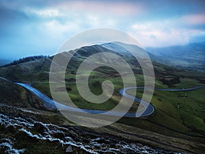 Rushup Edge, Edale Valley,  Derbyshire, UK - winding road with atmospheric clouds