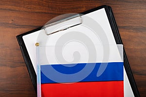 Rusian document, mockup for text on clipboard, white sheet of paper in a folder for notes with flag of russia