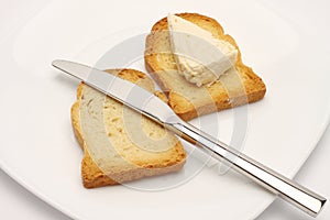 Rusk bread slice, cheese and knife